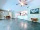 Open living area with eat-in kitchen, dining space, tile flooring, and ceiling fans at 1861 Royal Oak E Pl, Dunedin, FL 34698