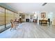 Bright, open living space with wood floors, a fireplace and large windows at 1861 Royal Oak E Pl, Dunedin, FL 34698