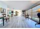 Spacious, bright living area with wood floors and large windows at 1861 Royal Oak E Pl, Dunedin, FL 34698