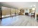 Bright living room with large window, wood floors, fireplace and built in shelves at 1861 Royal Oak E Pl, Dunedin, FL 34698