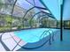 Screened in pool with clear blue water and ladder at 1861 Royal Oak E Pl, Dunedin, FL 34698