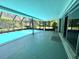 Spacious screened-in patio with a pool and sliding glass doors to the interior at 1861 Royal Oak E Pl, Dunedin, FL 34698
