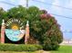 Dunedin Causeway welcome sign, featuring lush greenery and a glimpse of the scenic waterfront at 1861 Royal Oak E Pl, Dunedin, FL 34698