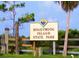 Honeymoon Island State Park sign amidst lush greenery and a wooden fence at 1861 Royal Oak E Pl, Dunedin, FL 34698