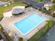 Aerial view of a community pool with lounge chairs and mature landscaping at 1881 N Hercules Ave # 1501, Clearwater, FL 33765