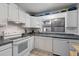 Bright kitchen featuring white cabinetry, modern appliances, and tiled flooring at 1881 N Hercules Ave # 1501, Clearwater, FL 33765