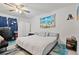 Airy bedroom with beach themed decor, neutral walls, a ceiling fan, and lots of natural light at 1881 N Hercules Ave # 1501, Clearwater, FL 33765