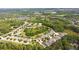 High angle aerial view of the community, showcasing the neighborhood's proximity to woods and lakes at 19418 Butterwood Ln, Lutz, FL 33558
