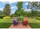 Charming backyard patio with colorful Adirondack chairs, perfect for outdoor relaxation at 19418 Butterwood Ln, Lutz, FL 33558