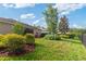 Well-maintained backyard featuring lush landscaping and a screened-in lanai at 19418 Butterwood Ln, Lutz, FL 33558