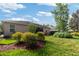 Well-maintained backyard featuring lush landscaping and a screened-in lanai at 19418 Butterwood Ln, Lutz, FL 33558
