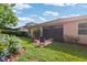 Spacious backyard showcasing lush landscaping, a patio with colorful chairs, and privacy at 19418 Butterwood Ln, Lutz, FL 33558