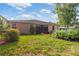 Well-maintained backyard featuring lush landscaping and a screened-in lanai at 19418 Butterwood Ln, Lutz, FL 33558