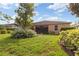 Lush backyard featuring a screen lanai, beautiful bushes and plenty of space at 19418 Butterwood Ln, Lutz, FL 33558