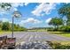 Outdoor basketball court featuring two hoops and surrounded by landscaping at 19418 Butterwood Ln, Lutz, FL 33558