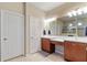 Bathroom with double vanities, tile flooring, and a large mirror, plus a private tiled shower at 19418 Butterwood Ln, Lutz, FL 33558