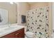 Clean bathroom featuring a single sink vanity, toilet, and tub with shower at 19418 Butterwood Ln, Lutz, FL 33558