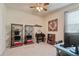 Cozy bedroom featuring carpeted floors, a ceiling fan, and versatile shelving at 19418 Butterwood Ln, Lutz, FL 33558