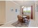 Bright dining area features a round table, four chairs and a large window with natural light at 19418 Butterwood Ln, Lutz, FL 33558