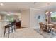 Open-concept dining area with a round table, wooden chairs, and seamless flow to living spaces at 19418 Butterwood Ln, Lutz, FL 33558