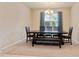 Dining room with carpeted floor, neutral walls, contemporary chandelier, and dark wood table with seating for six at 19418 Butterwood Ln, Lutz, FL 33558