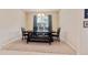 Dining room featuring a dark wood table with a bench and chairs beneath a modern chandelier with carpeted floors at 19418 Butterwood Ln, Lutz, FL 33558