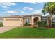 Inviting single-story home with a manicured lawn, brick-paved driveway, and cozy front porch in a well-kept neighborhood at 19418 Butterwood Ln, Lutz, FL 33558