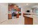 Open kitchen featuring stainless appliances, granite countertops, and ample space for cooking and entertaining at 19418 Butterwood Ln, Lutz, FL 33558