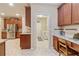 Well-designed kitchen with built-in desk, stainless steel fridge, and convenient access to the laundry room at 19418 Butterwood Ln, Lutz, FL 33558