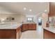 Spacious kitchen featuring granite counters, ample cabinetry, and a seamless flow to the dining area at 19418 Butterwood Ln, Lutz, FL 33558