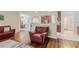 Open-concept living room features hardwood floors, kitchen bar, and stylish, comfortable seating at 19418 Butterwood Ln, Lutz, FL 33558