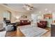 Spacious living room with hardwood floors, ceiling fan, and comfortable seating arrangement at 19418 Butterwood Ln, Lutz, FL 33558