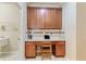 Convenient office nook with granite countertop, custom cabinetry, and easy access to the laundry area at 19418 Butterwood Ln, Lutz, FL 33558