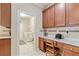 Kitchen office nook featuring granite counters and laundry room access for convenience at 19418 Butterwood Ln, Lutz, FL 33558