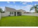 Spacious backyard with screened-in patio and lush green grass at 21284 Southern Charm Dr, Land O Lakes, FL 34637