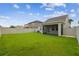 Large backyard with covered lanai and lush green grass at 21284 Southern Charm Dr, Land O Lakes, FL 34637
