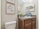 Bathroom vanity with granite countertop, decor and framed art at 21284 Southern Charm Dr, Land O Lakes, FL 34637