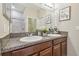 Bathroom featuring a double sink vanity with granite countertops and a large mirror at 21284 Southern Charm Dr, Land O Lakes, FL 34637