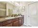 Bathroom with double sink vanity, granite countertop, and framed mirror at 21284 Southern Charm Dr, Land O Lakes, FL 34637