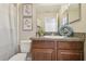 Bathroom vanity with granite countertop, decor and framed art at 21284 Southern Charm Dr, Land O Lakes, FL 34637