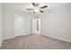 Empty bedroom features neutral carpet, ceiling fan, and closet for a customizable and comfortable space at 21284 Southern Charm Dr, Land O Lakes, FL 34637