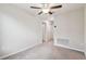 Empty bedroom with neutral carpet, ceiling fan, white trim, and a closet for a customizable space at 21284 Southern Charm Dr, Land O Lakes, FL 34637