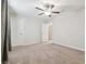 Empty bedroom features neutral carpet, ceiling fan, and closet for a customizable and comfortable space at 21284 Southern Charm Dr, Land O Lakes, FL 34637