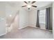 Loft area with neutral carpet, ceiling fan, window, and curtains, for a versatile living space at 21284 Southern Charm Dr, Land O Lakes, FL 34637