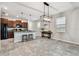 Spacious open-concept dining area adjacent to a well-equipped kitchen with tile flooring at 21284 Southern Charm Dr, Land O Lakes, FL 34637