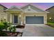 Charming single-Gathering home with a two-car garage and well-maintained front yard at 21284 Southern Charm Dr, Land O Lakes, FL 34637