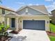 Single-Gathering home featuring a two-car garage and landscaping at 21284 Southern Charm Dr, Land O Lakes, FL 34637