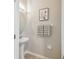 Half bathroom with pedestal sink, framed artwork, and decorative towels at 21284 Southern Charm Dr, Land O Lakes, FL 34637