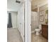 Hallway with bathroom showcasing a vanity, toilet, and tub/shower combo, seamlessly connecting living spaces at 21284 Southern Charm Dr, Land O Lakes, FL 34637