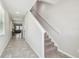 Light and airy hallway featuring tile flooring and a staircase at 21284 Southern Charm Dr, Land O Lakes, FL 34637